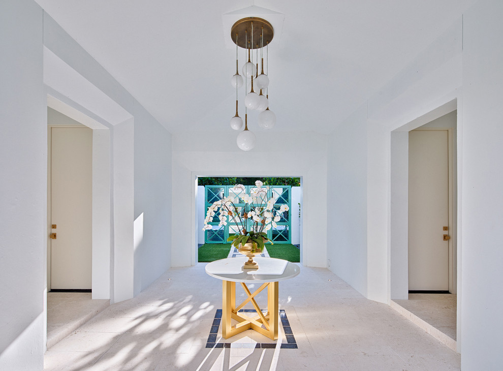 Large contemporary foyer in Orlando with white walls, limestone floors, a double front door, a glass front door and white floor.