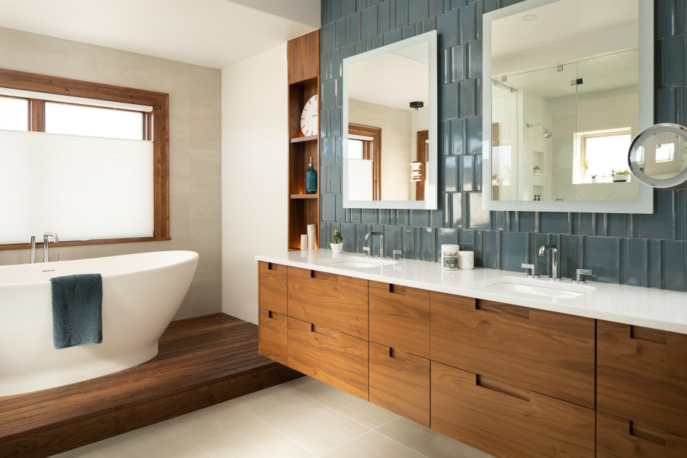 Photo of a large contemporary ensuite bathroom in Denver with flat-panel cabinets, dark wood cabinets, a freestanding bath, a built-in shower, ceramic tiles, porcelain flooring, a submerged sink, engineered stone worktops, a hinged door, white worktops, double sinks and a floating vanity unit.