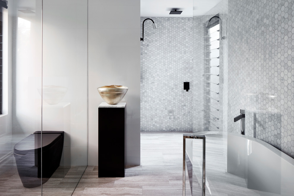 This is an example of a large contemporary master bathroom in Sydney with a freestanding tub, a double shower, white tile, marble, white walls, travertine floors, a vessel sink, grey floor, an open shower and white benchtops.