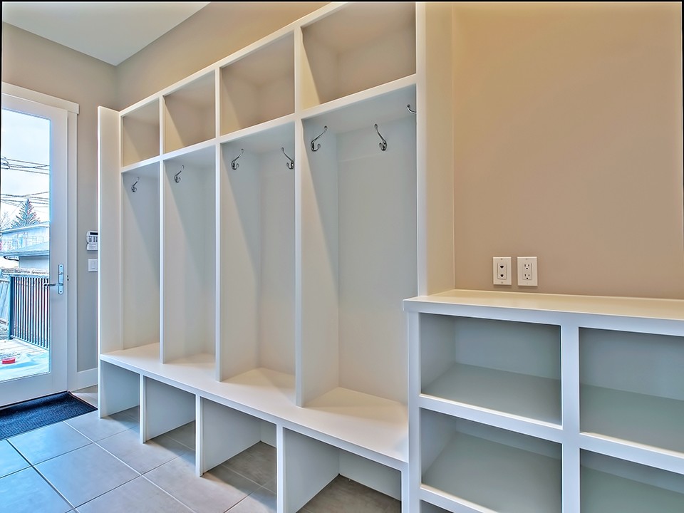 Large modern mudroom in Calgary with white walls.
