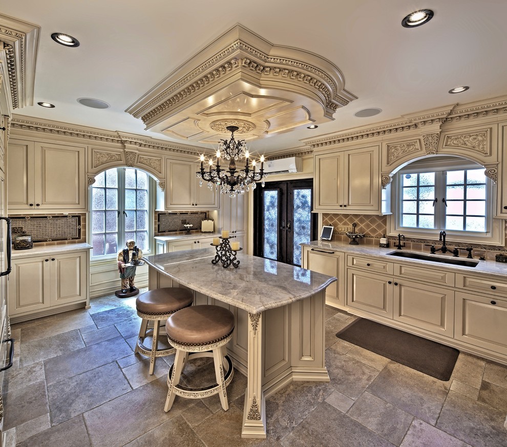 This is an example of a large traditional u-shaped open plan kitchen in Philadelphia with a single-bowl sink, raised-panel cabinets, beige cabinets, marble benchtops, multi-coloured splashback, ceramic splashback, stainless steel appliances, porcelain floors and with island.