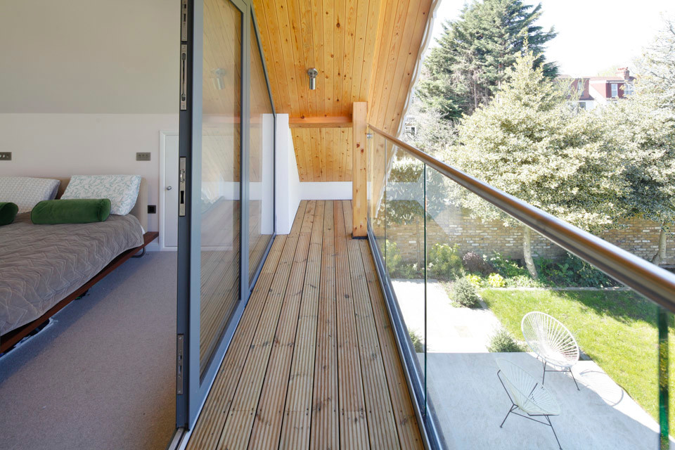 Large contemporary balcony in Surrey with glass railing.