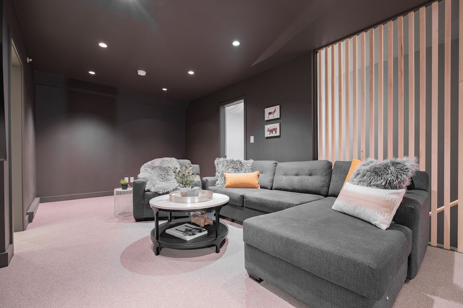 Photo of a large contemporary open concept home theatre in Other with grey walls, carpet, a wall-mounted tv and grey floor.