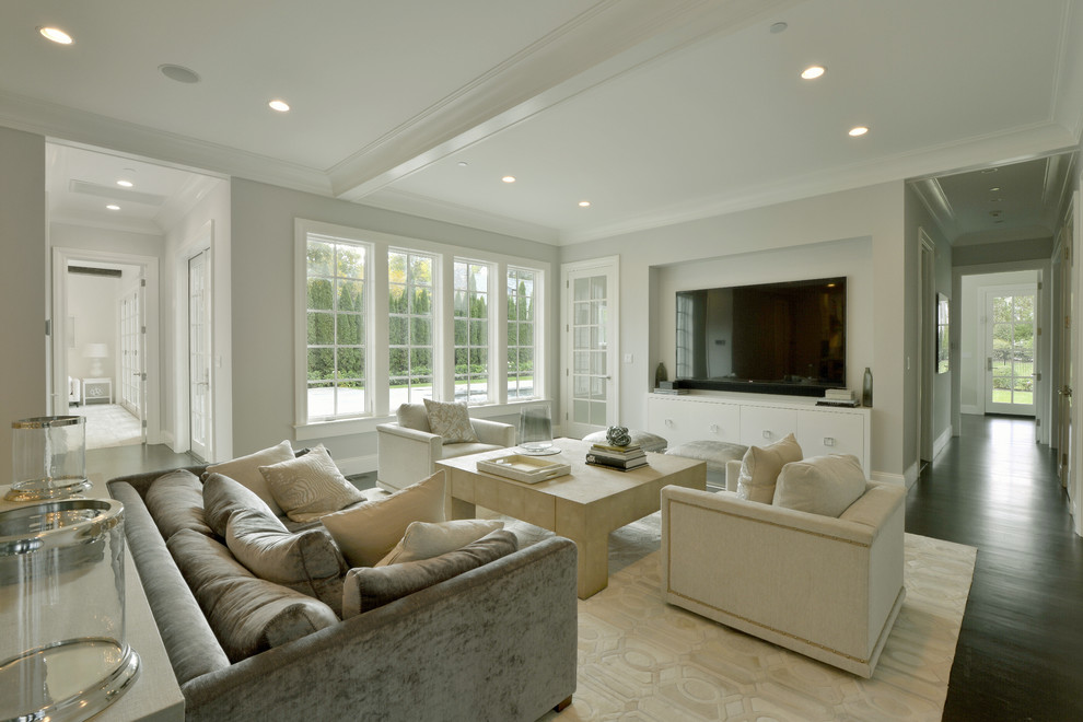 Photo of a large transitional family room in New York with grey walls, no fireplace and a wall-mounted tv.