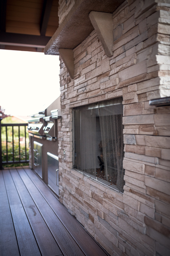 Huge mountain style backyard outdoor kitchen deck photo in Indianapolis with a roof extension