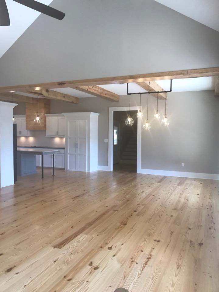 Photo of a large country open plan dining in Other with grey walls, light hardwood floors, no fireplace, beige floor and exposed beam.