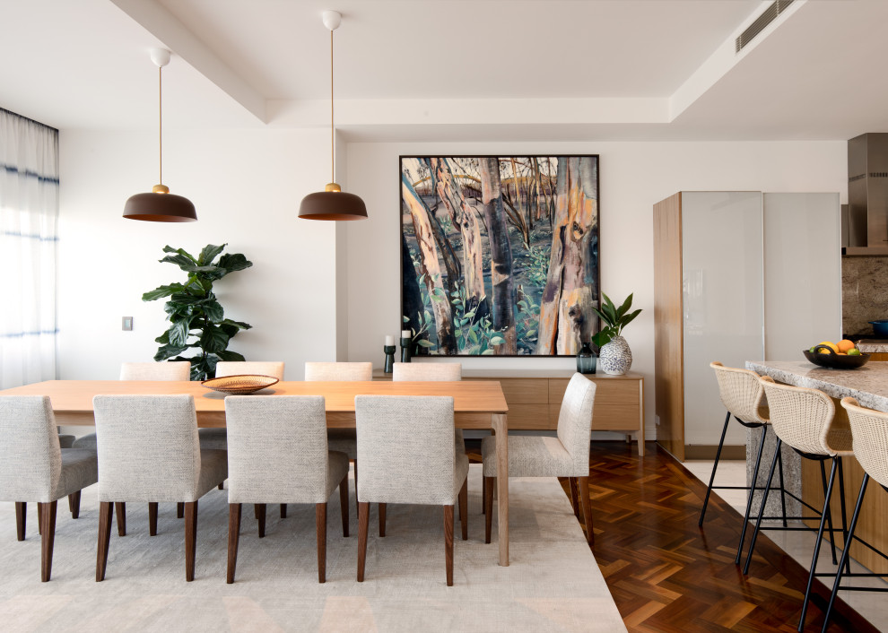 Design ideas for a large contemporary open plan dining in Melbourne with white walls, medium hardwood floors and brown floor.
