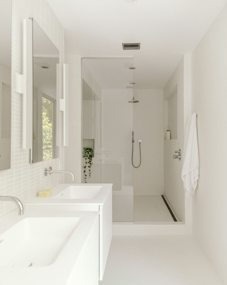 Inspiration for a small modern master bathroom in New York with white cabinets, white tile, ceramic tile, white walls, concrete floors, white floor, an open shower, white benchtops, a double vanity and a floating vanity.