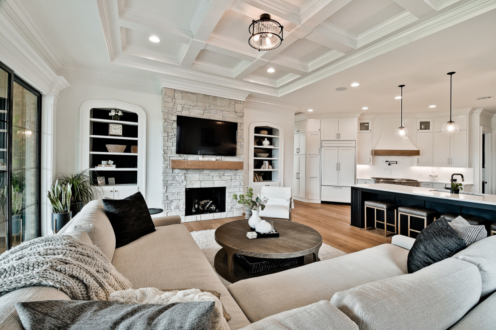 Inspiration for a large transitional open concept family room in Other with white walls, light hardwood floors, a standard fireplace, a stone fireplace surround, a wall-mounted tv and coffered.