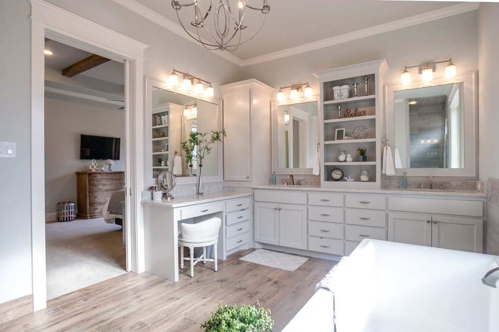 Inspiration for a large country master bathroom in Dallas with shaker cabinets, a freestanding tub, a curbless shower, gray tile, grey walls, ceramic floors, an undermount sink, marble benchtops and white cabinets.