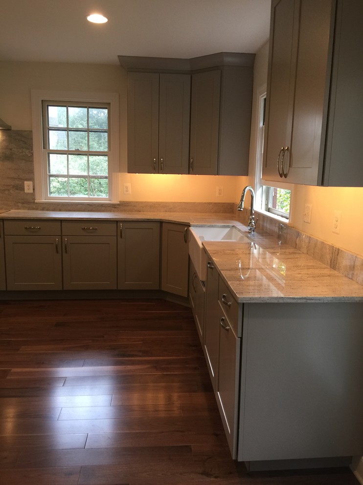 Inspiration for a large transitional l-shaped dark wood floor eat-in kitchen remodel in Baltimore with stainless steel appliances, an undermount sink, shaker cabinets, white cabinets, marble countertops, gray backsplash, stone slab backsplash and an island