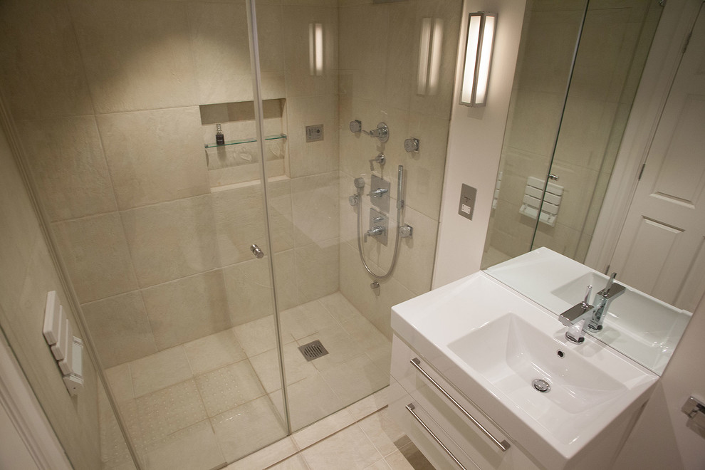 This is an example of a small contemporary master bathroom in London with flat-panel cabinets, white cabinets, an open shower, a one-piece toilet, beige tile, porcelain tile, beige walls, porcelain floors, a console sink and engineered quartz benchtops.