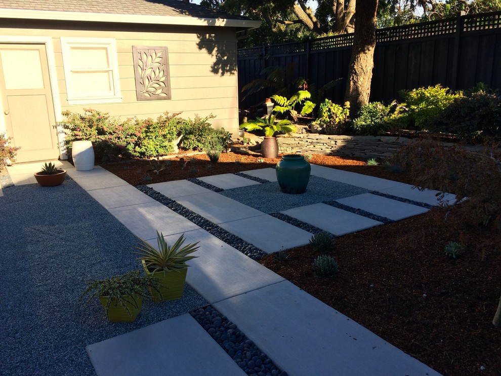 Design ideas for a small asian backyard partial sun garden for summer in San Francisco with a retaining wall and concrete pavers.