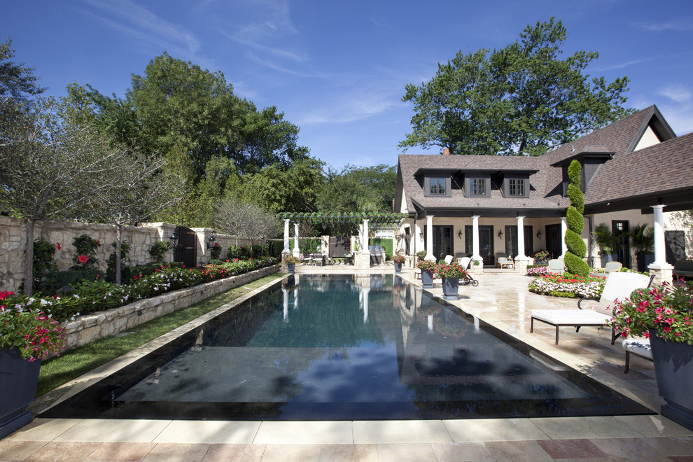 Large contemporary backyard rectangular lap pool in Chicago with a water feature and concrete pavers.