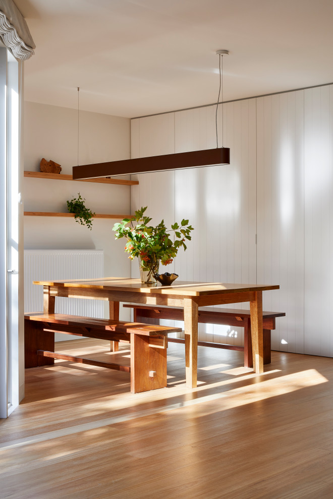 Inspiration för en mellanstor funkis matplats med öppen planlösning, med vita väggar, ljust trägolv och beiget golv