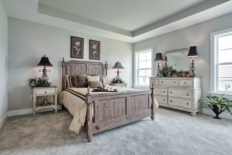 Large arts and crafts master bedroom in Other with beige walls, carpet, no fireplace and beige floor.