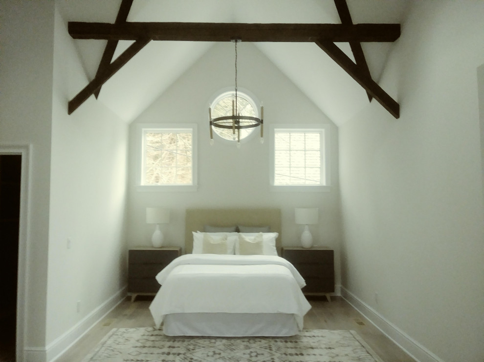 Mid-sized contemporary guest bedroom in Other with white walls, laminate floors and beige floor.