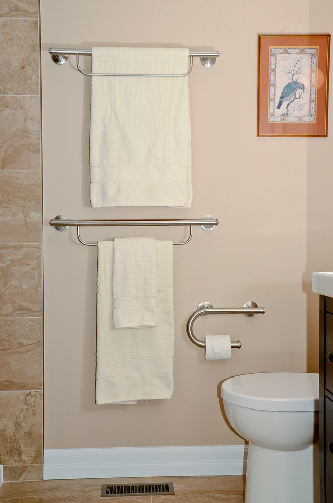 Small transitional master brown tile and porcelain tile porcelain tile home design photo in Ottawa with shaker cabinets, dark wood cabinets, a two-piece toilet, beige walls, an undermount sink and solid surface countertops