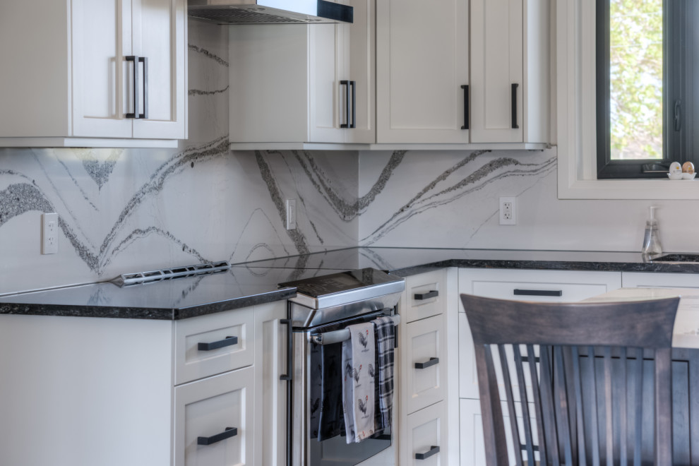 Transitional eat-in kitchen photo with shaker cabinets, white cabinets, stainless steel appliances and an island