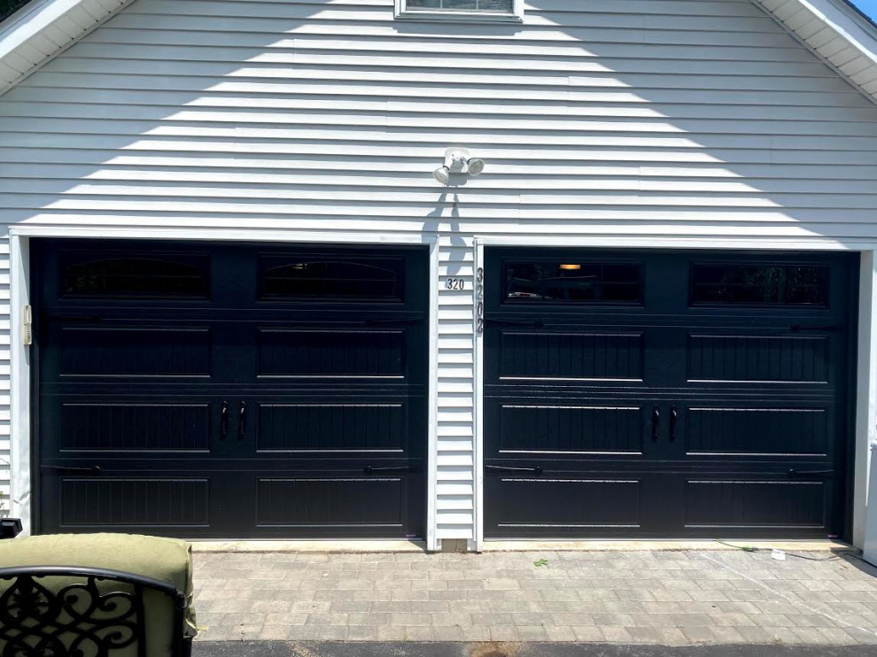 Photo of a mid-sized transitional attached two-car garage in Other.