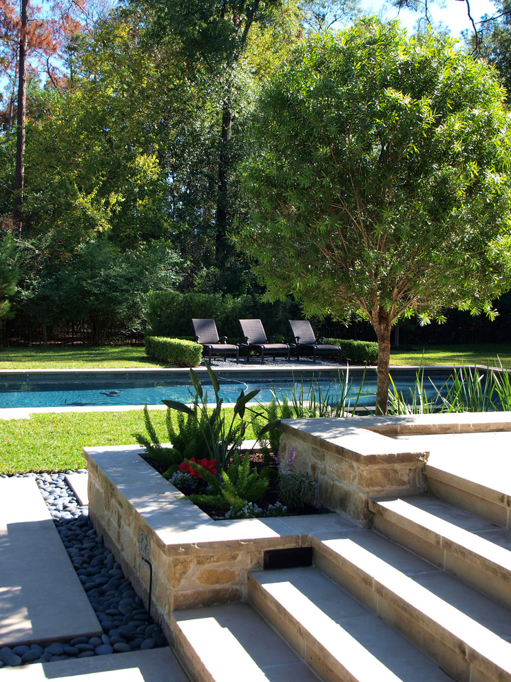 Design ideas for a mid-sized contemporary backyard partial sun garden in Houston with concrete pavers.