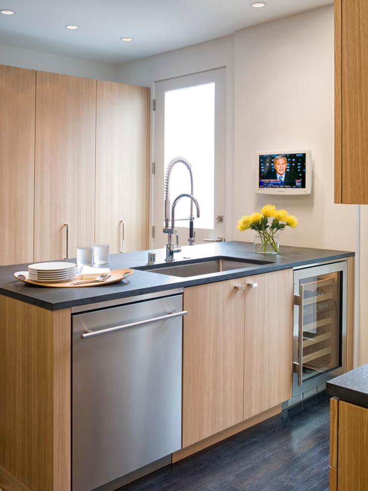 Design ideas for a mid-sized modern galley eat-in kitchen in San Francisco with an undermount sink, flat-panel cabinets, light wood cabinets, stainless steel appliances, dark hardwood floors, with island, brown splashback, solid surface benchtops and stone slab splashback.