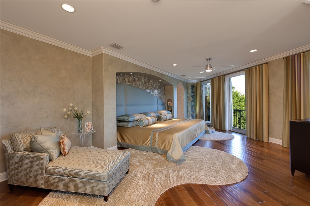Contemporary bedroom in Miami with beige walls and medium hardwood floors.