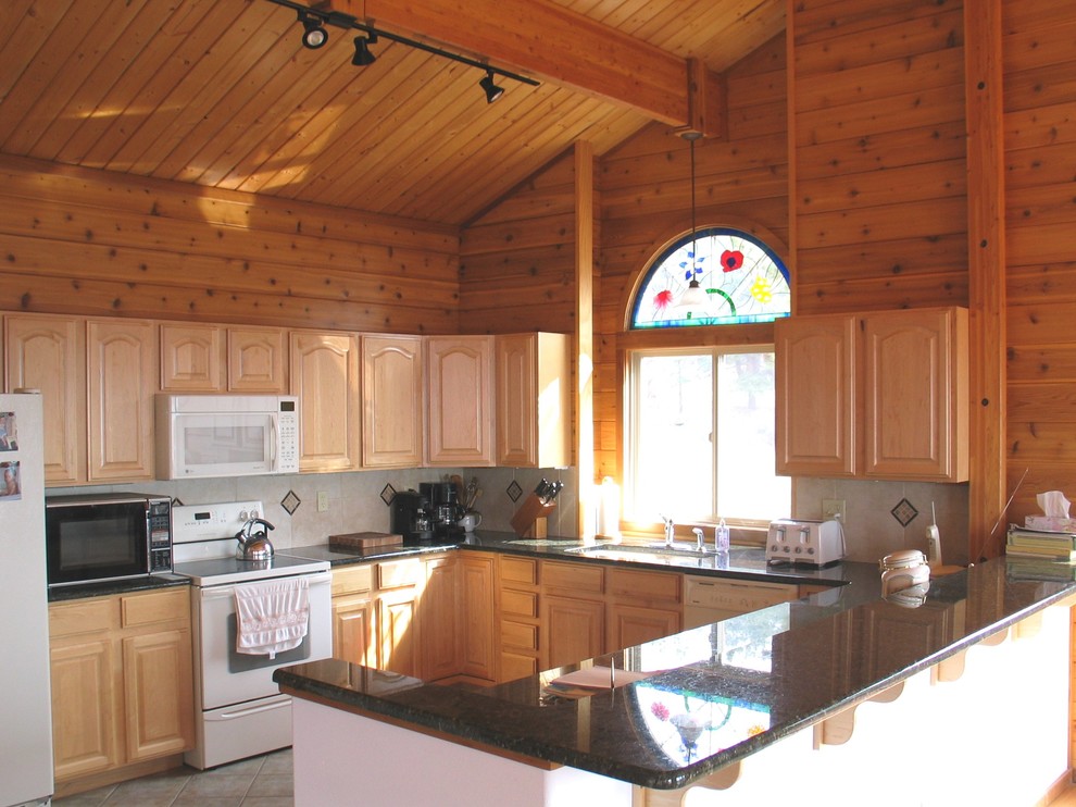 Open concept kitchen - mid-sized rustic u-shaped ceramic tile and beige floor open concept kitchen idea in Denver with an undermount sink, beige backsplash, raised-panel cabinets, light wood cabinets, granite countertops, ceramic backsplash, white appliances and no island