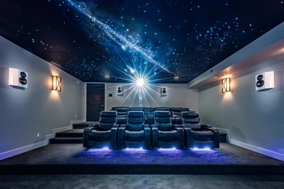Large modern enclosed home theatre in Salt Lake City with white walls, carpet, a projector screen and grey floor.