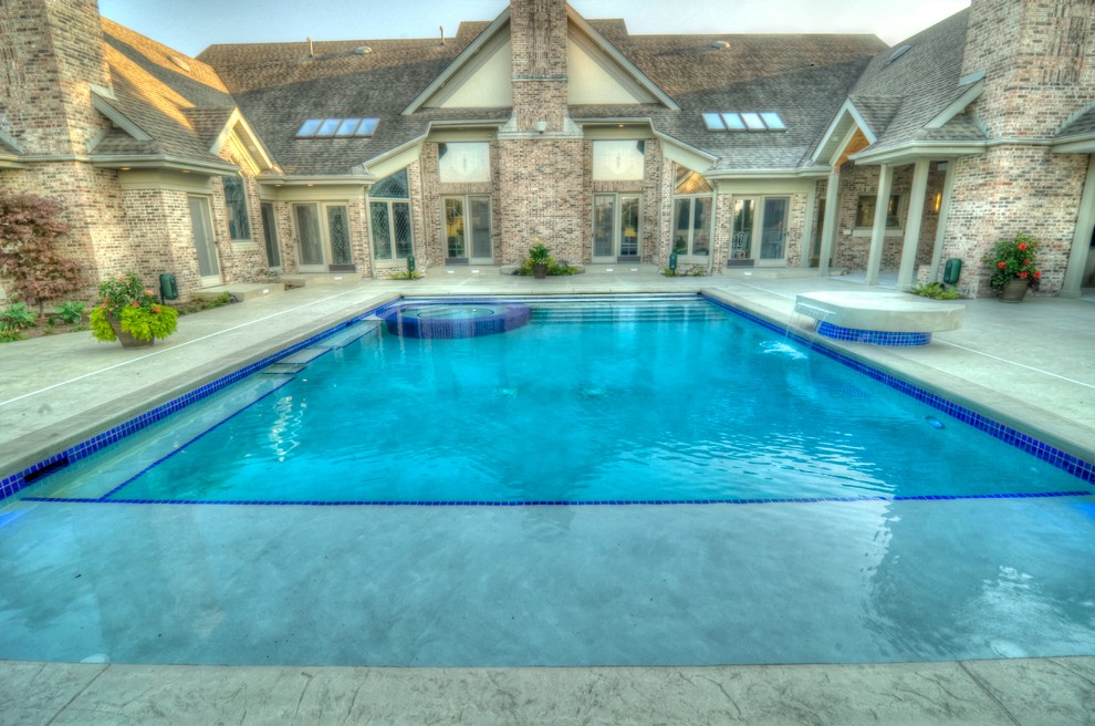 Hot tub - large transitional backyard concrete paver and rectangular natural hot tub idea in Cedar Rapids