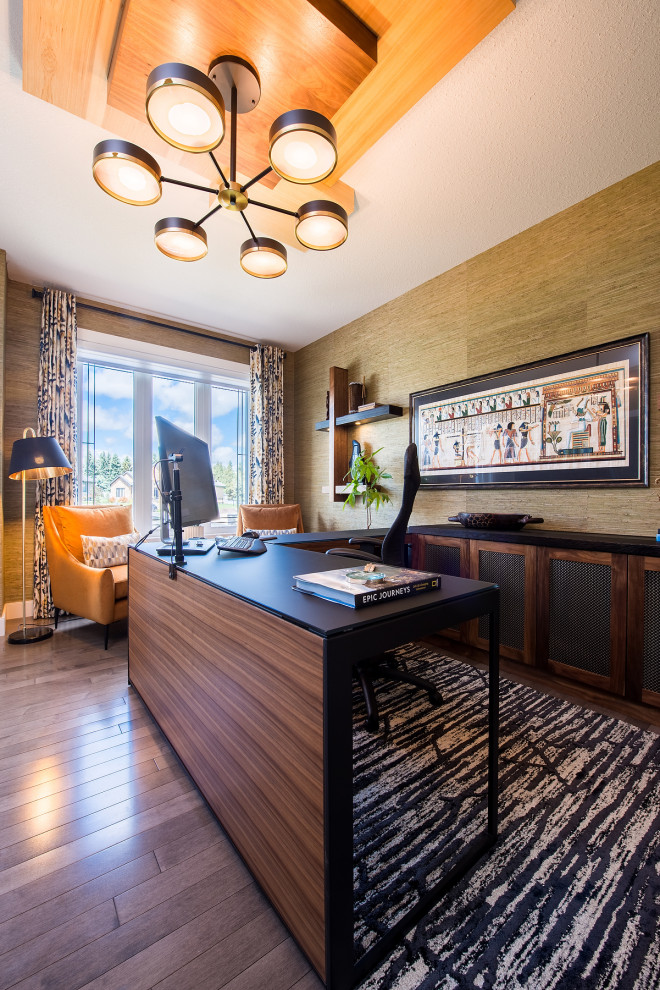 Mid-sized transitional study room in Edmonton with green walls, medium hardwood floors, a freestanding desk, brown floor, wood and wallpaper.