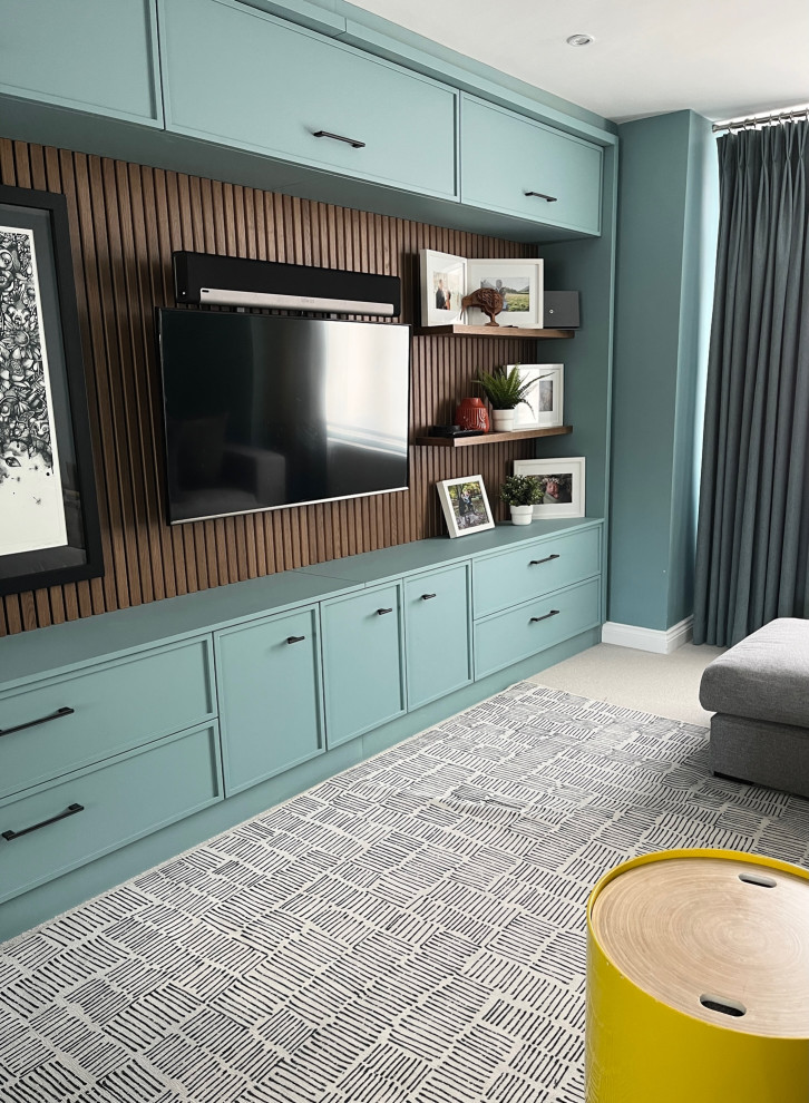 Design ideas for a contemporary living room in London with blue walls, carpet and beige floors.