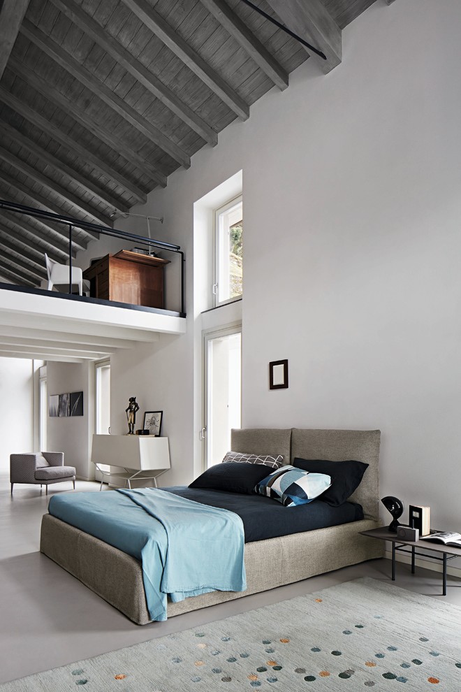 Inspiration for a large transitional master bedroom in DC Metro with white walls, concrete floors and beige floor.