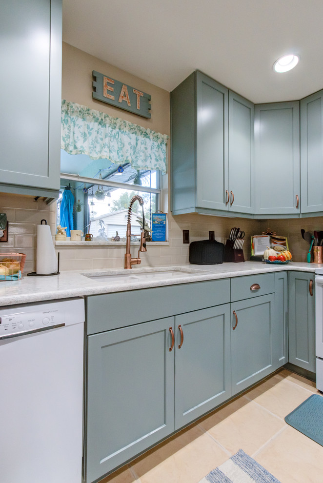 This is an example of a small eclectic u-shaped separate kitchen in Other with an undermount sink, shaker cabinets, turquoise cabinets, quartz benchtops, beige splashback, white appliances and turquoise benchtop.