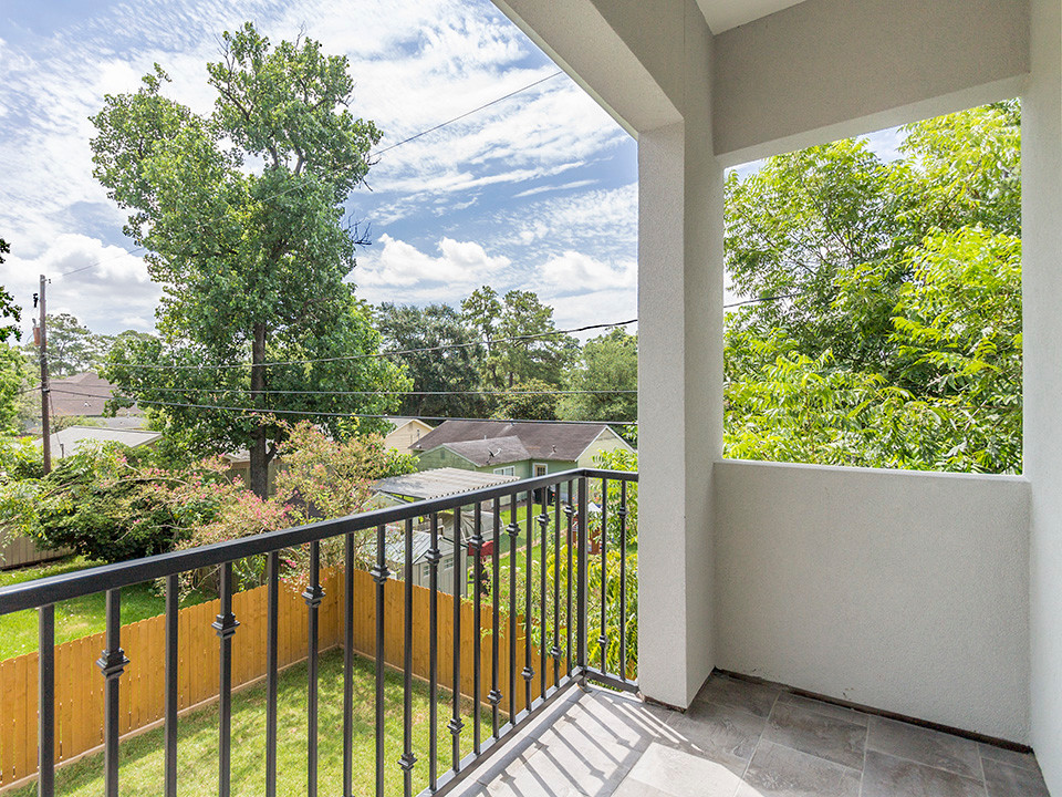 Small transitional backyard deck photo in Houston with a roof extension