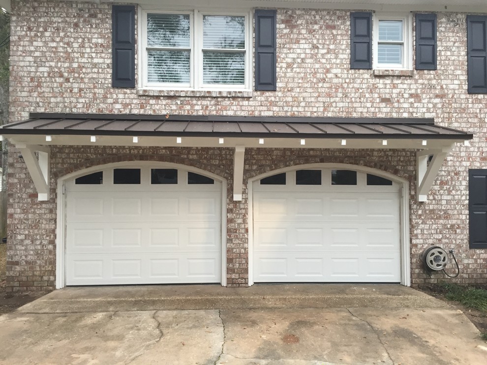 Photo of a mid-sized traditional four-car garage in Charleston.
