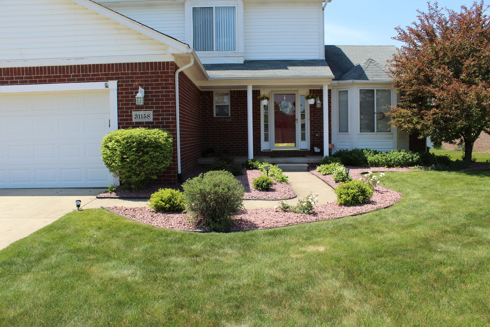 Design ideas for a small modern front yard full sun driveway in Detroit with a garden path and concrete pavers.