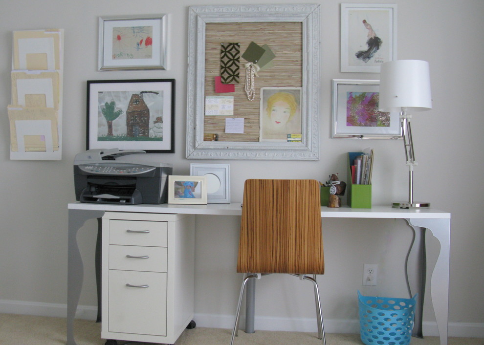 This is an example of a traditional home office in Philadelphia with white walls, carpet and a freestanding desk.