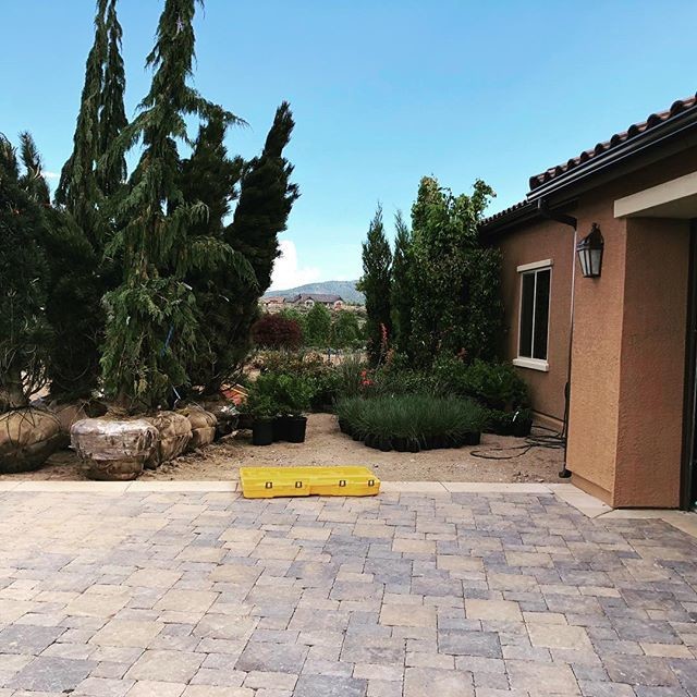 Inspiration for a mid-sized mediterranean front yard full sun garden in Salt Lake City with with rock feature and river rock.