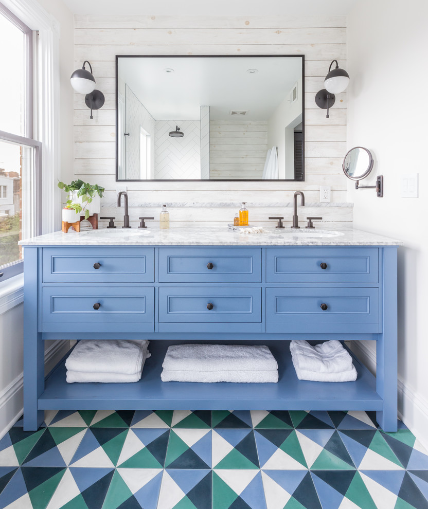 Design ideas for an eclectic bathroom in DC Metro with recessed-panel cabinets, blue cabinets, white walls, cement tiles, an undermount sink and multi-coloured floor.