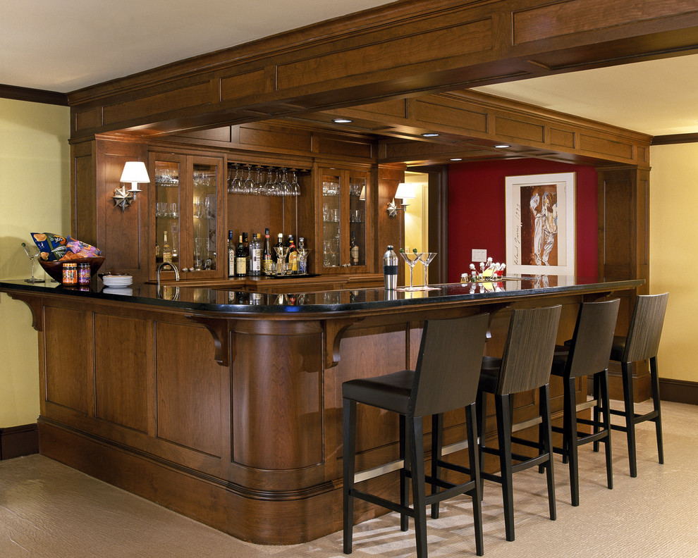 Large traditional u-shaped seated home bar in Boston with an undermount sink, recessed-panel cabinets, dark wood cabinets, granite benchtops, brown splashback, timber splashback, carpet and beige floor.