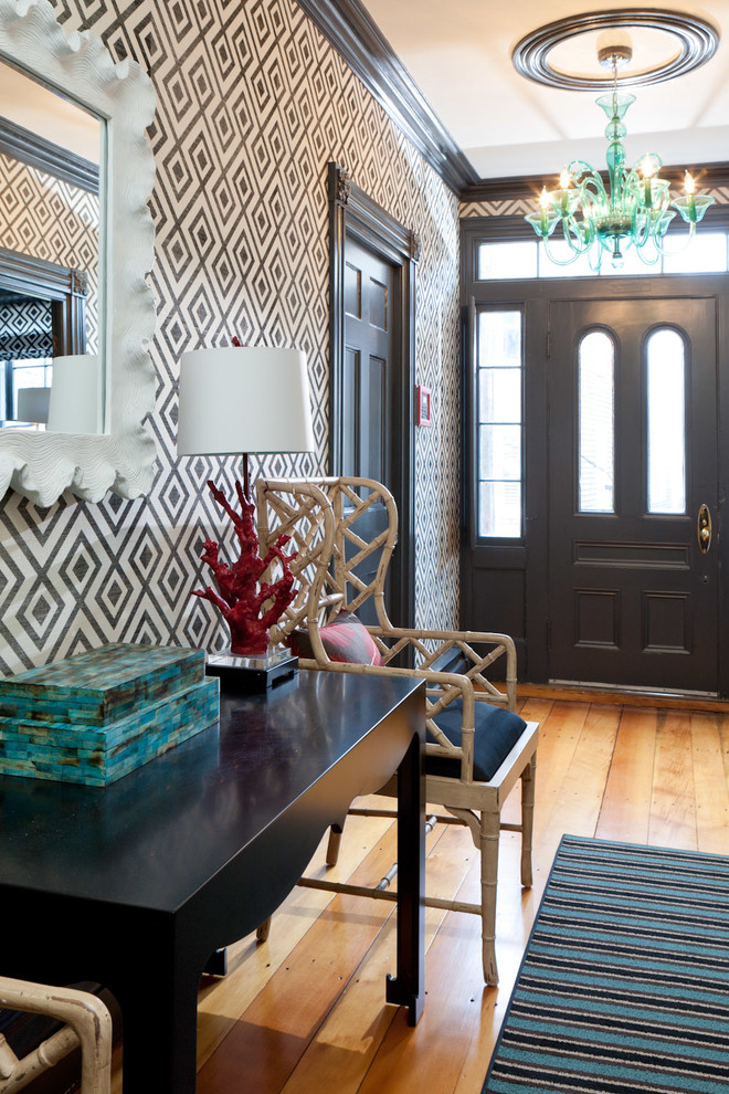 Inspiration for an eclectic entryway in Boston with medium hardwood floors, a single front door, a black front door and multi-coloured walls.