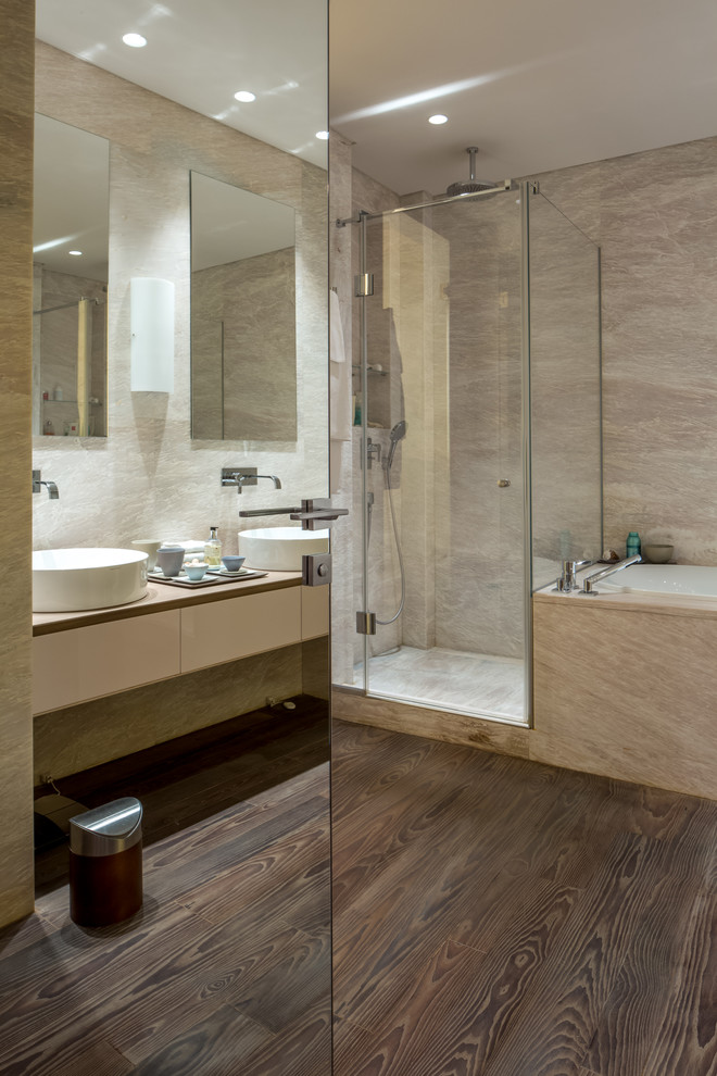 This is an example of a contemporary bathroom in Moscow with flat-panel cabinets, beige cabinets, beige walls and a vessel sink.