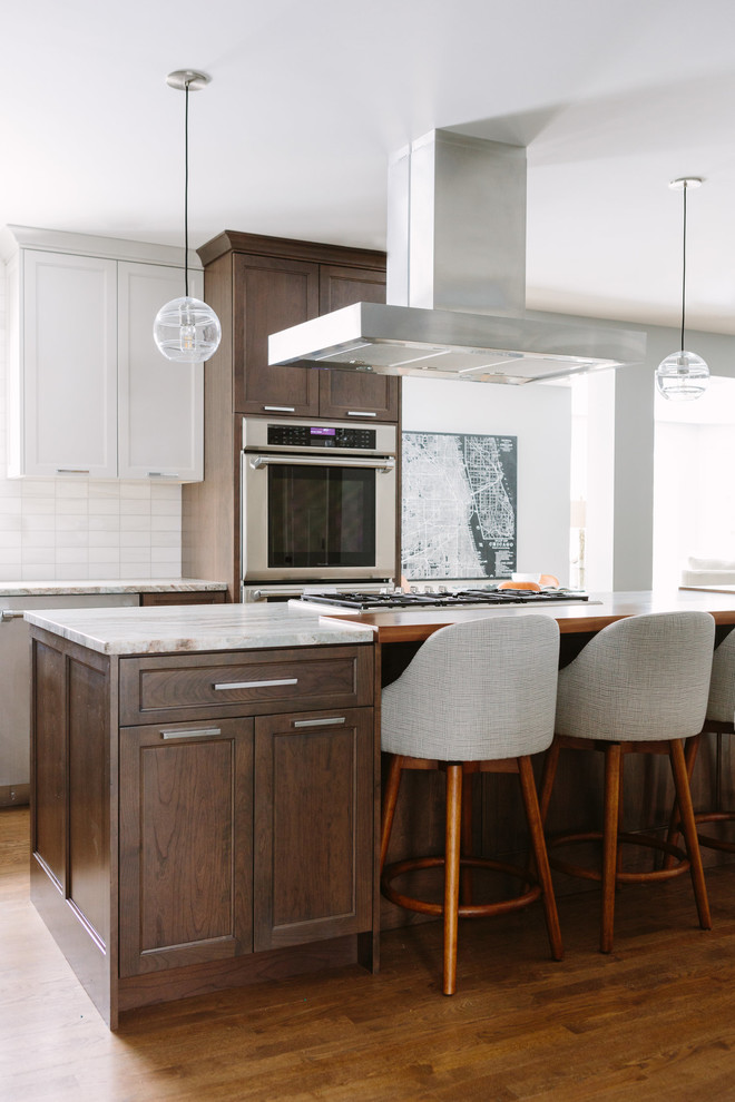 Eat-in kitchen - transitional u-shaped dark wood floor and brown floor eat-in kitchen idea in Chicago with an undermount sink, shaker cabinets, dark wood cabinets, marble countertops, beige backsplash, stainless steel appliances, an island and beige countertops