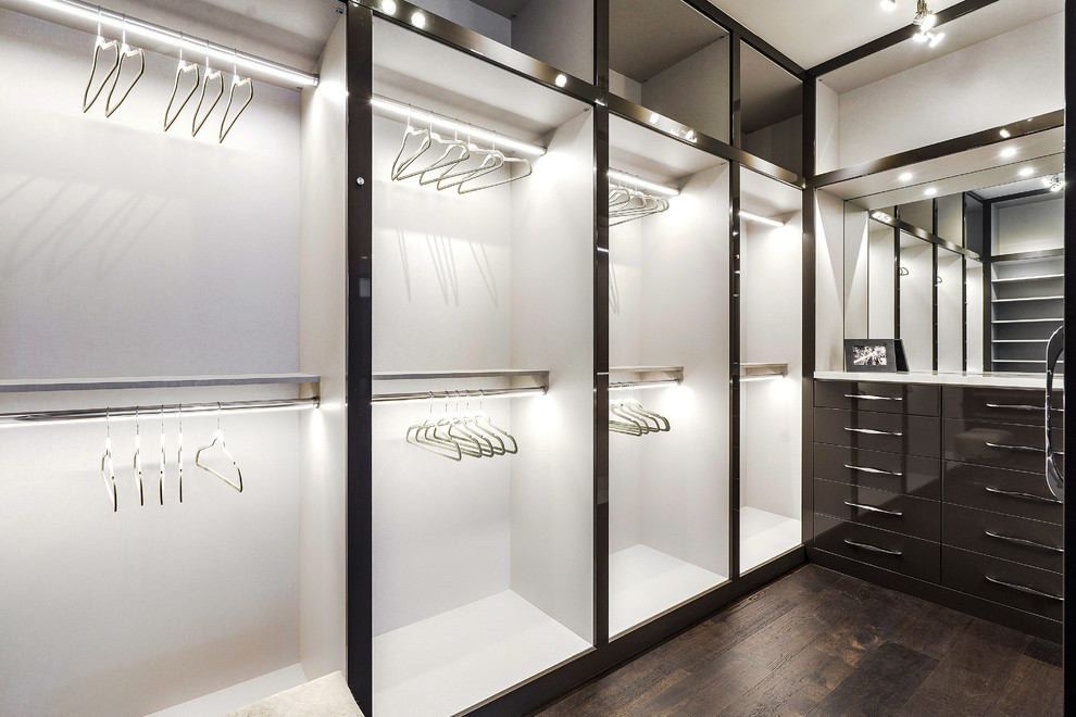 Large modern gender-neutral dressing room in Miami with flat-panel cabinets, dark wood cabinets, medium hardwood floors and brown floor.