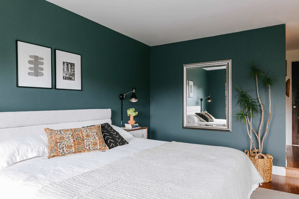 Photo of a large contemporary master bedroom in San Francisco with green walls and dark hardwood floors.