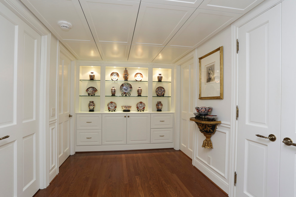 Photo of a traditional hallway in Houston with white walls and medium hardwood floors.