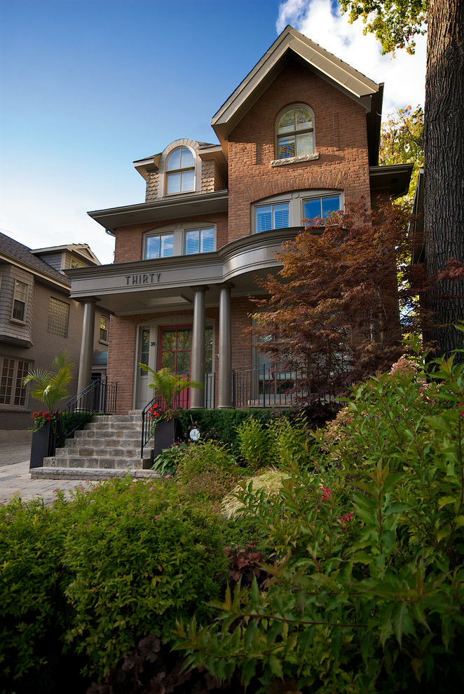 Photo of a traditional three-storey brick exterior in Toronto.
