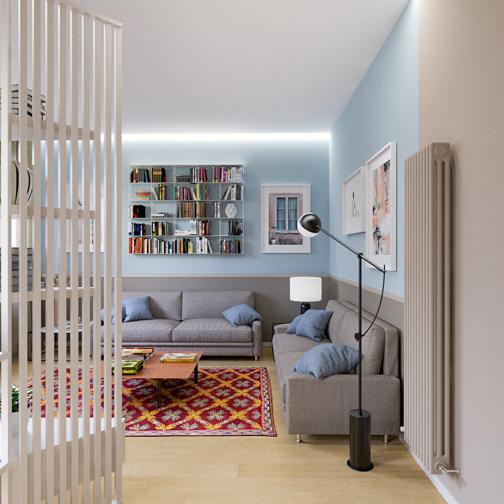 Design ideas for a mid-sized contemporary open concept living room in Milan with a library, blue walls, light hardwood floors and a built-in media wall.