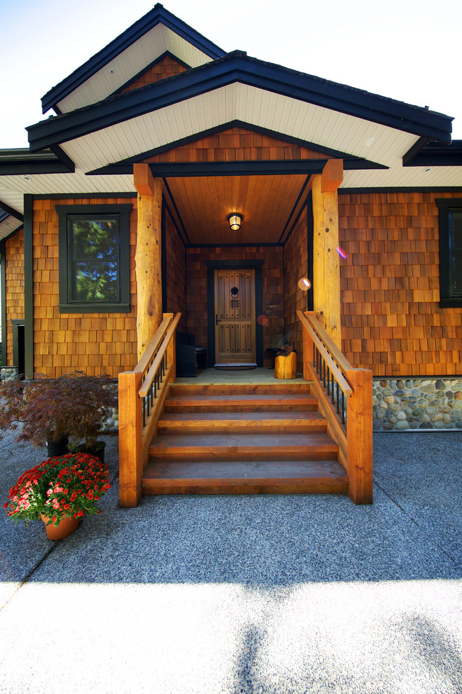Rustic brown two-story concrete fiberboard exterior home idea in Vancouver with a clipped gable roof